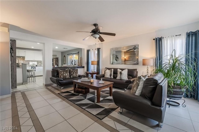 living room featuring ceiling fan and light tile patterned flooring