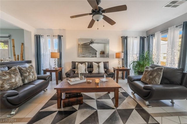 tiled living room featuring ceiling fan and a wealth of natural light