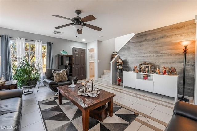 tiled living room with wood walls and ceiling fan