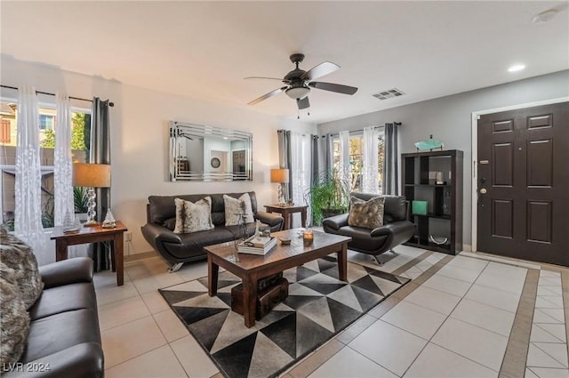 tiled living room featuring ceiling fan and a healthy amount of sunlight