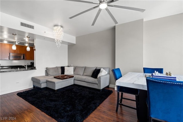 living room featuring dark hardwood / wood-style flooring and a notable chandelier