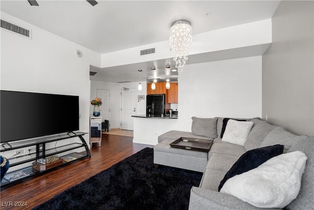 living room featuring dark hardwood / wood-style floors and a notable chandelier