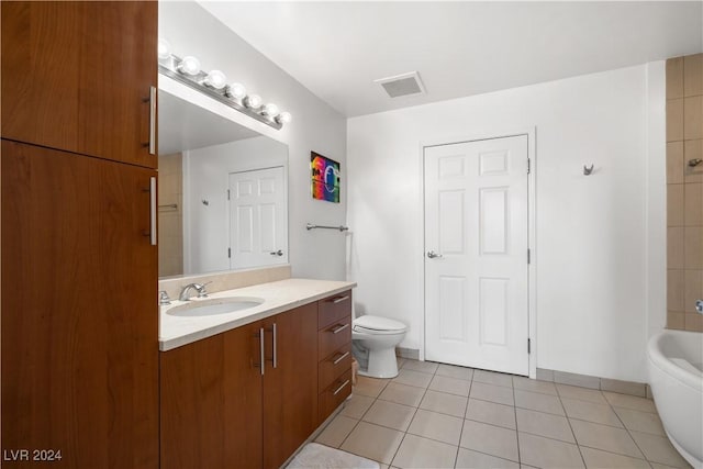 bathroom with tile patterned flooring, vanity, and toilet