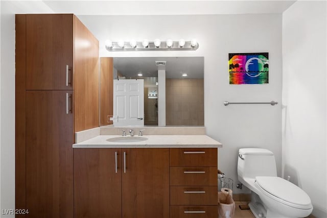 bathroom with tile patterned flooring, vanity, and toilet