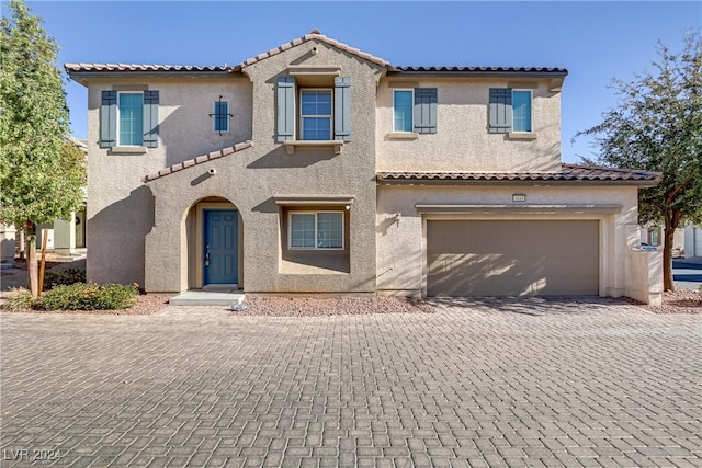 mediterranean / spanish-style home featuring a garage