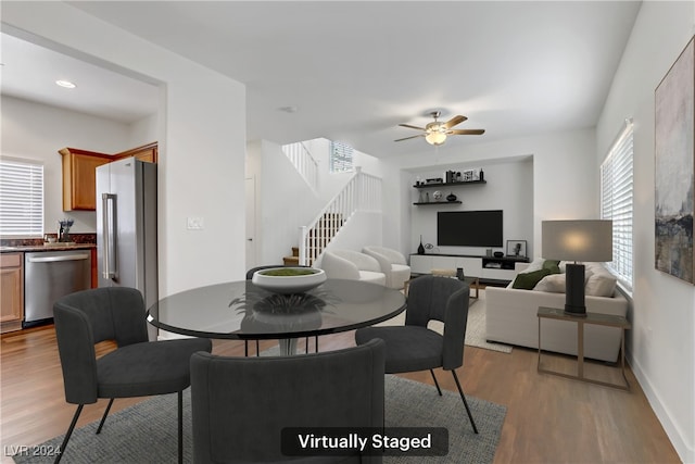 dining space with ceiling fan, a wealth of natural light, and light hardwood / wood-style flooring