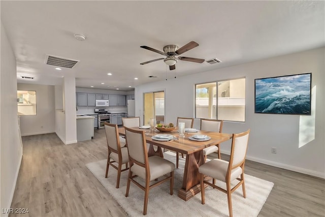 dining area with visible vents, baseboards, and light wood-style floors