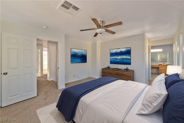 bedroom with visible vents, light carpet, baseboards, and a ceiling fan