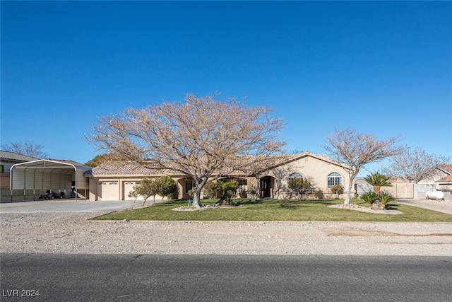 view of front of house featuring a front lawn, a garage, and a carport