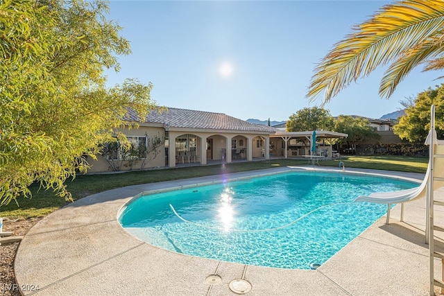 view of pool featuring a yard and a water slide