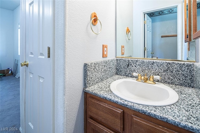 bathroom featuring vanity and tasteful backsplash