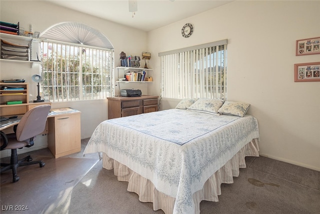 bedroom with light colored carpet, multiple windows, and ceiling fan