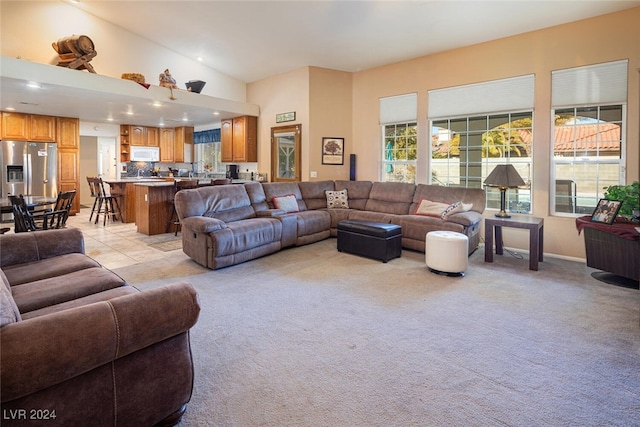 living room with light carpet and lofted ceiling