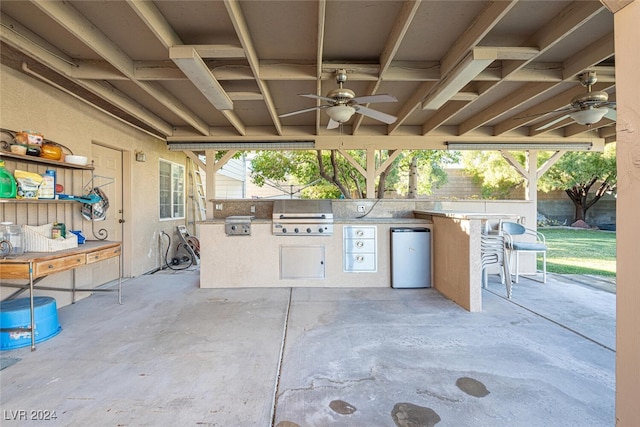 view of patio / terrace with exterior bar, grilling area, ceiling fan, and exterior kitchen