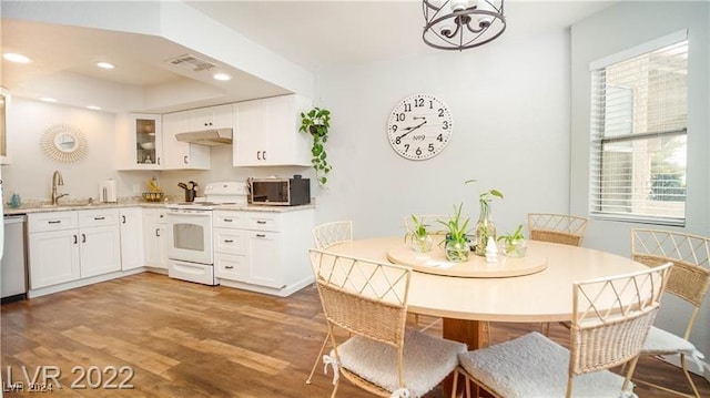 kitchen featuring white cabinetry, plenty of natural light, wood-type flooring, and appliances with stainless steel finishes