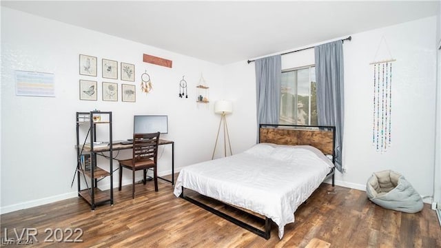 bedroom featuring dark hardwood / wood-style flooring