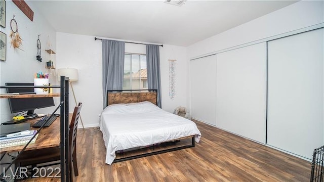 bedroom with hardwood / wood-style floors and a closet