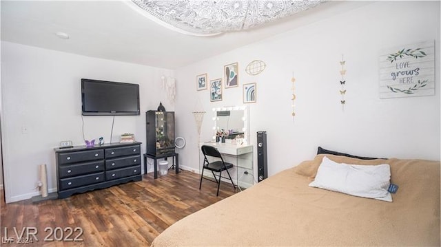 bedroom with dark wood-type flooring