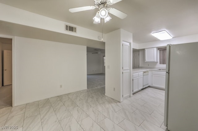 kitchen featuring white appliances, visible vents, ceiling fan, light countertops, and white cabinetry