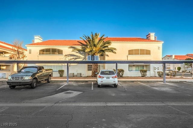 view of building exterior with uncovered parking