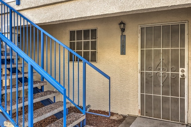 property entrance with stucco siding