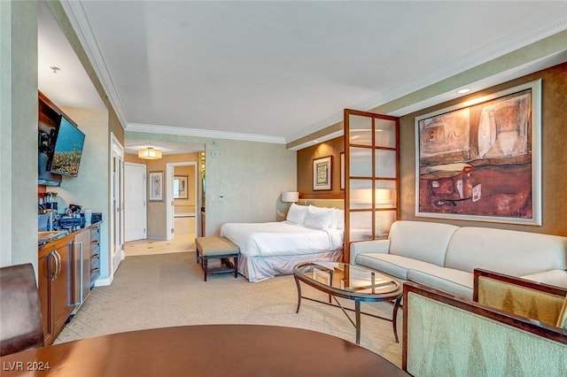 bedroom featuring ornamental molding and ensuite bath