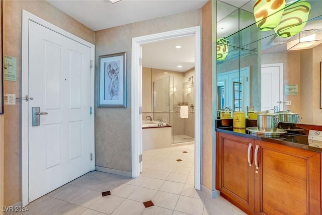 bathroom with tile patterned floors, vanity, and walk in shower