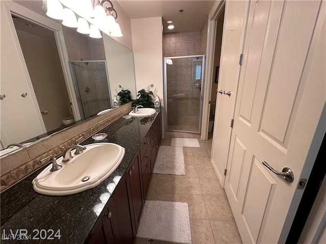 bathroom featuring tile patterned floors, walk in shower, vanity, a chandelier, and toilet