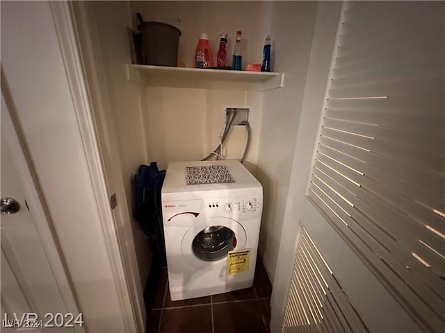 washroom with washer / clothes dryer and dark tile patterned flooring