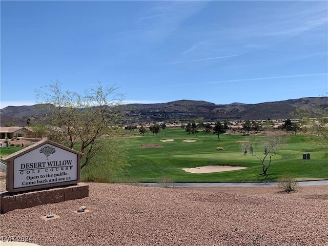 view of home's community with a mountain view and a yard