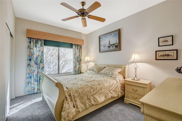 carpeted bedroom featuring ceiling fan and a closet