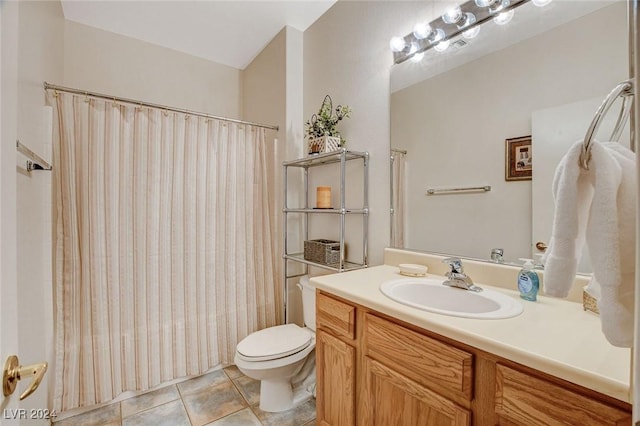 bathroom featuring tile patterned flooring, vanity, and toilet