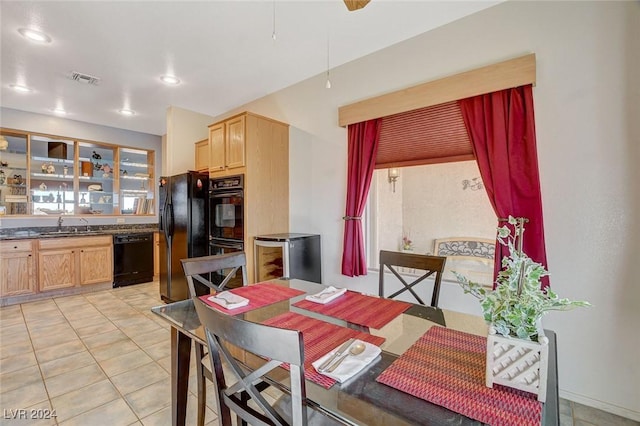 dining room featuring sink and light tile patterned floors