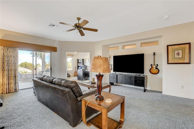 carpeted living room with ceiling fan