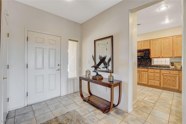 entryway with light tile patterned flooring