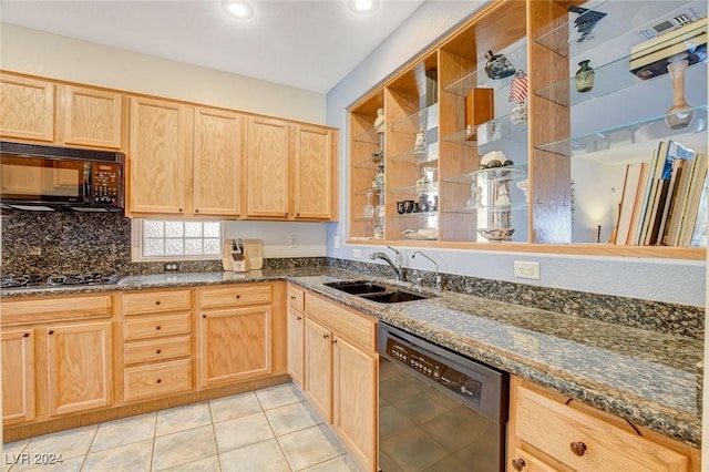 kitchen featuring black appliances, light tile patterned flooring, sink, and dark stone counters