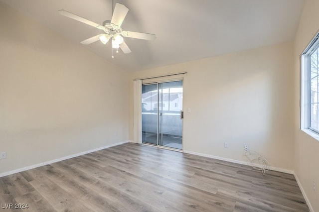 unfurnished room with ceiling fan, lofted ceiling, plenty of natural light, and light hardwood / wood-style flooring