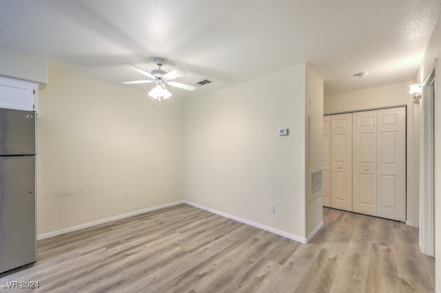 interior space with a textured ceiling, light hardwood / wood-style flooring, and ceiling fan