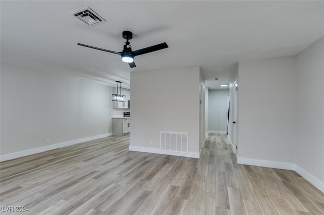 unfurnished living room featuring ceiling fan and light hardwood / wood-style floors