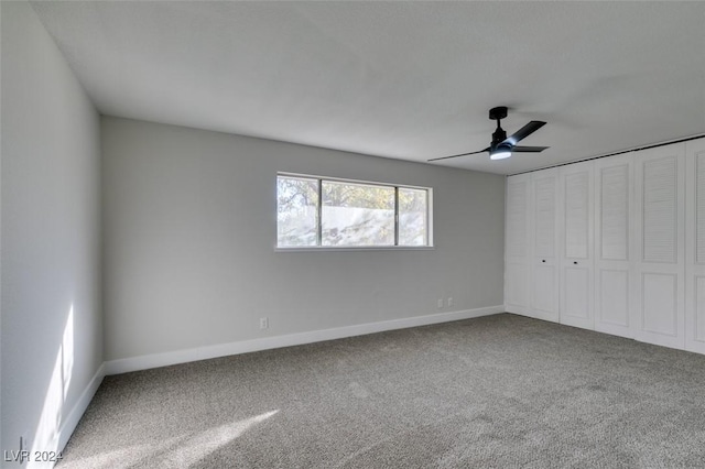 unfurnished bedroom featuring ceiling fan, carpet floors, and a closet