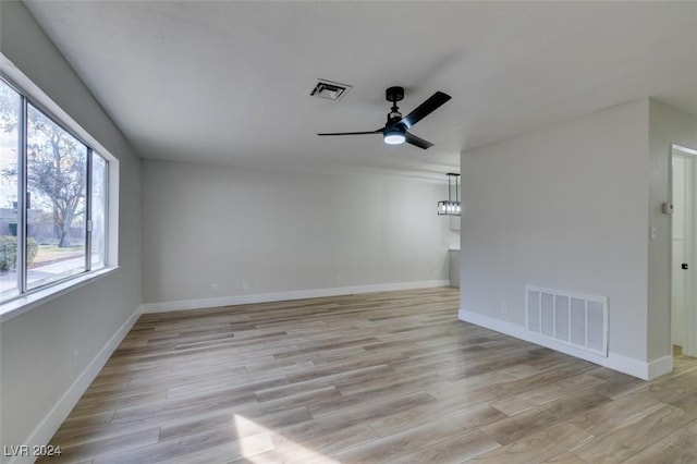 unfurnished room with ceiling fan and light hardwood / wood-style floors