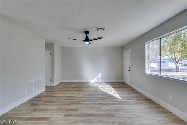 empty room with light hardwood / wood-style flooring and ceiling fan