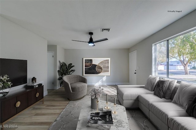 living room featuring ceiling fan and light hardwood / wood-style floors