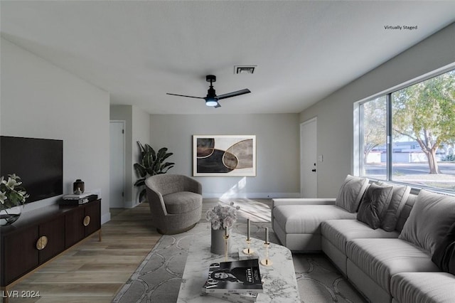 living room featuring light hardwood / wood-style floors and ceiling fan