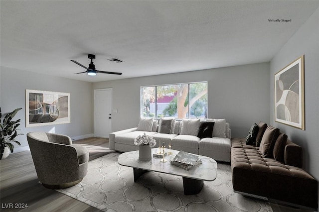 living room with light hardwood / wood-style flooring and ceiling fan