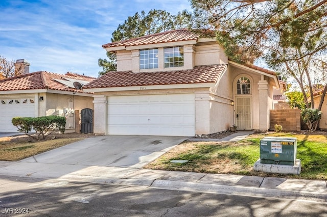 mediterranean / spanish home with a garage