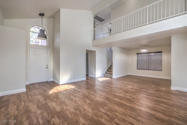 entrance foyer featuring dark hardwood / wood-style flooring and high vaulted ceiling