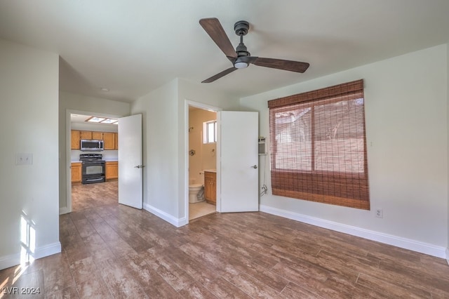 spare room with ceiling fan and dark wood-type flooring