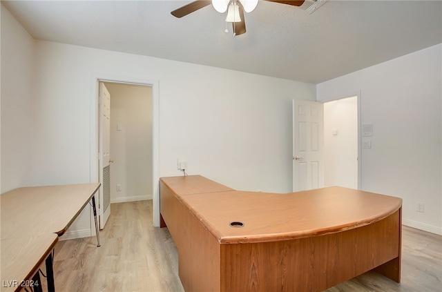 home office with ceiling fan and light hardwood / wood-style flooring