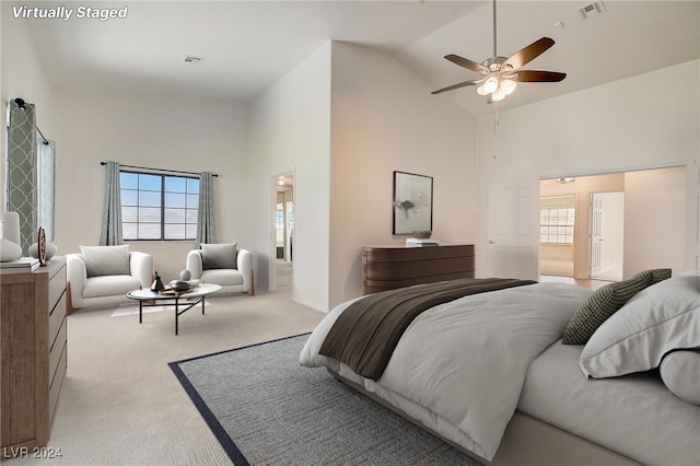 bedroom featuring ceiling fan, high vaulted ceiling, and light colored carpet